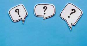 - Shine Mental Health Three white speech bubbles with black question marks, set against a bright blue background, conveying questions or inquiry.