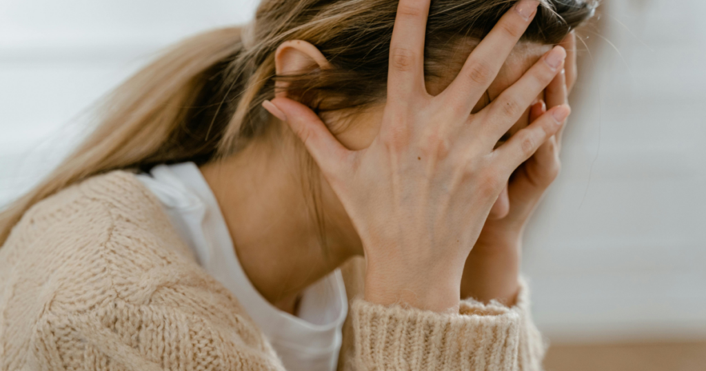 feeling-of-impending-doom-body-triggers-image-1 - Shine Mental Health Person covering their face with both hands, suggesting distress or frustration.